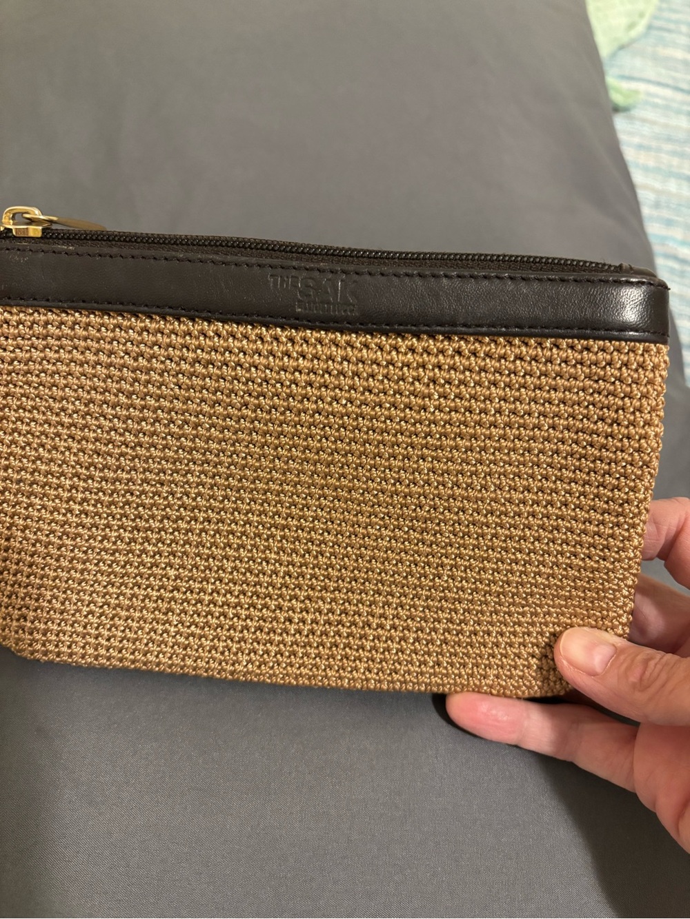 The Sak crochet clutch dark brown leather trimmed.